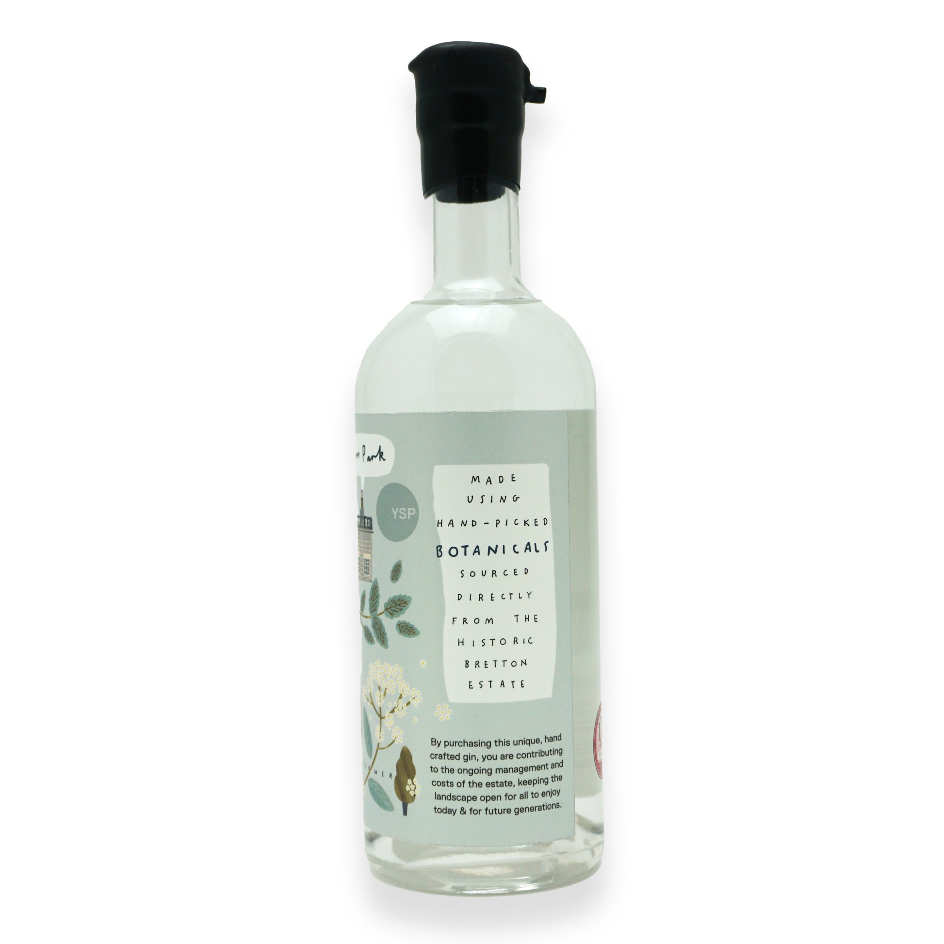 The side of a large glass bottle with black wax dipping on the neck, with a blue label featuring illustrations of botanicals found around Yorkshire Sculpture Park.
