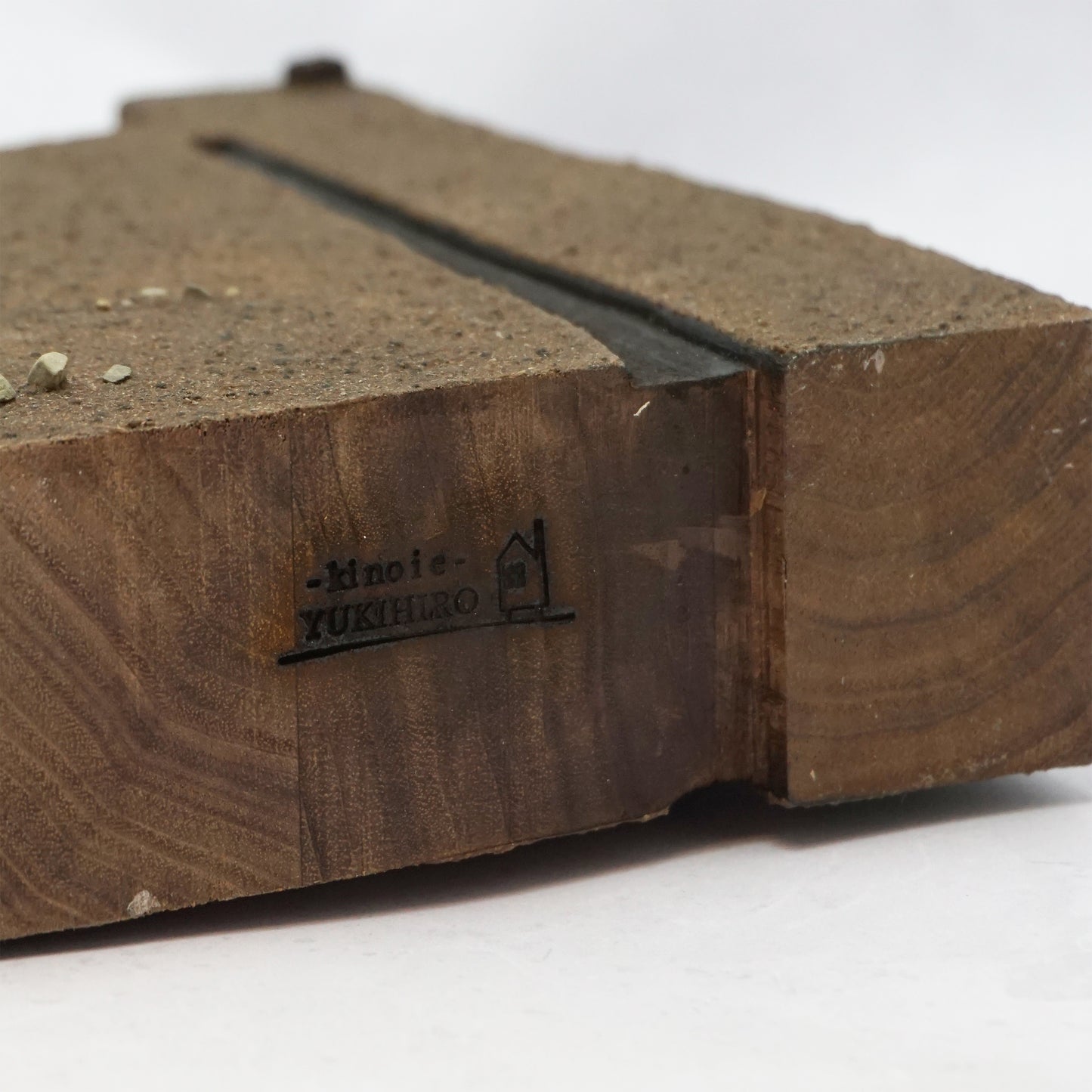 Wooden base of house with a the branded name 'Kinoie YUKIHIRO' on a white background