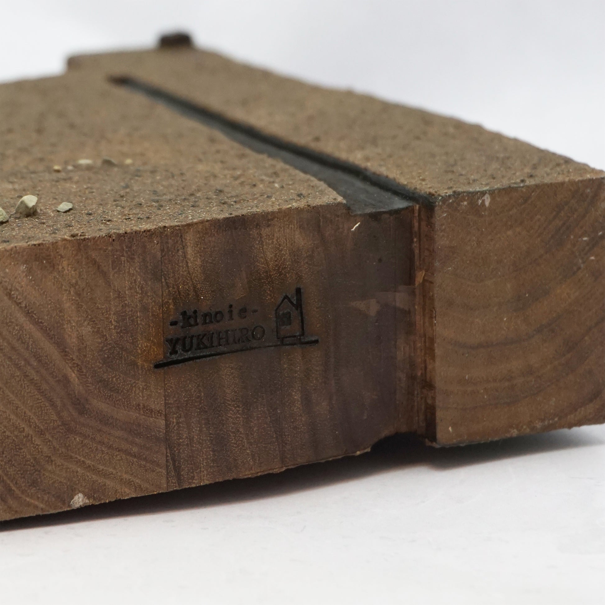 Wooden base of house with a the branded name 'Kinoie YUKIHIRO' on a white background