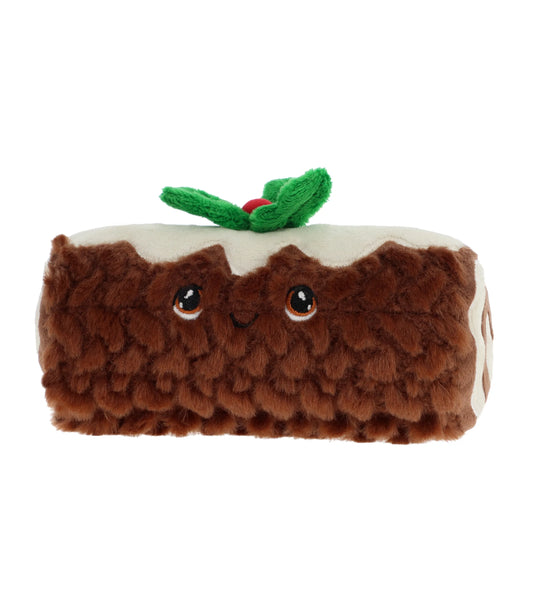 Plush toy resembling a Christmas yule log with a cherry on top against a white background