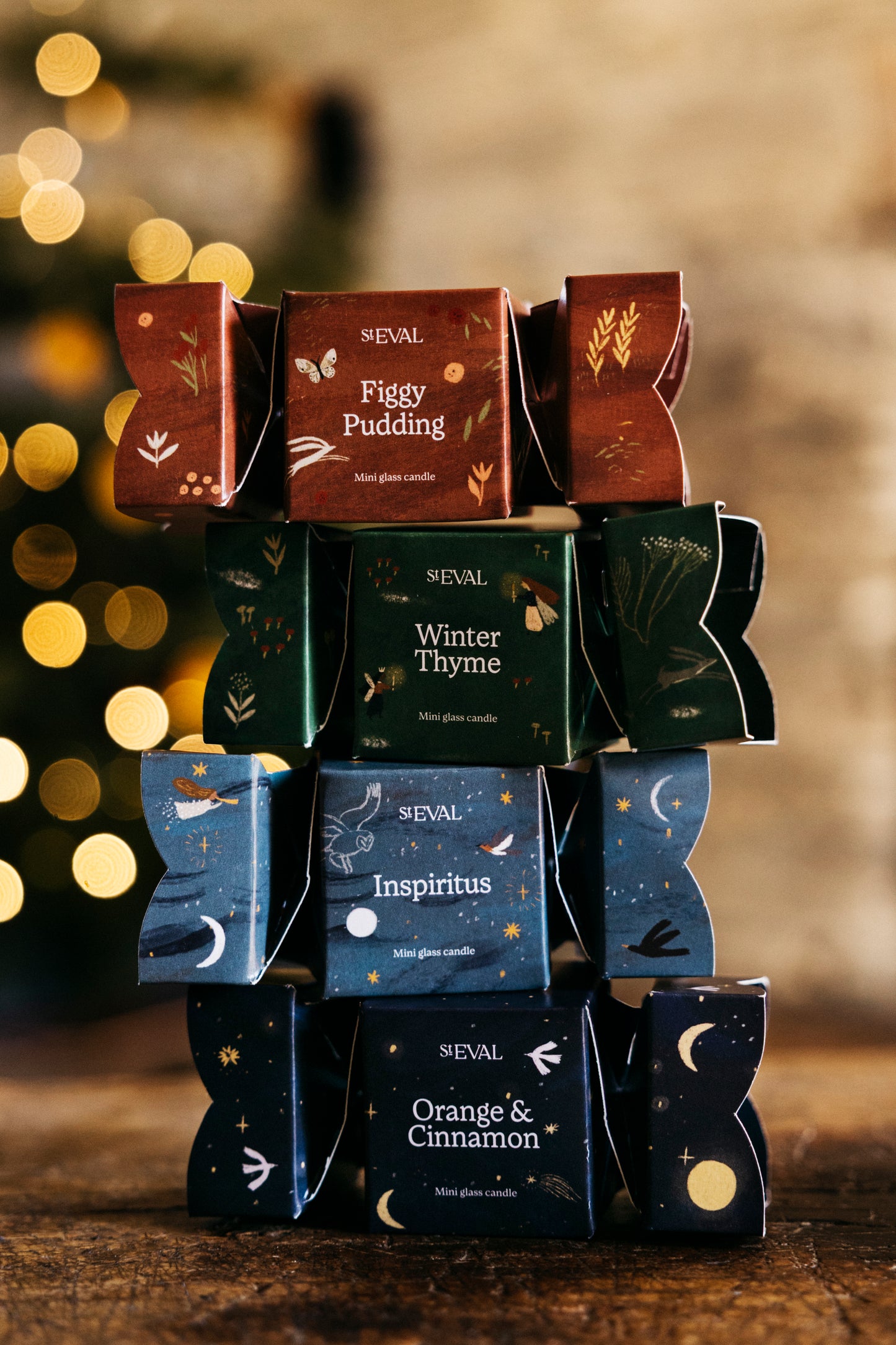 Stack of St Eval holiday Christmas cracker candles with a warm, blurred background.