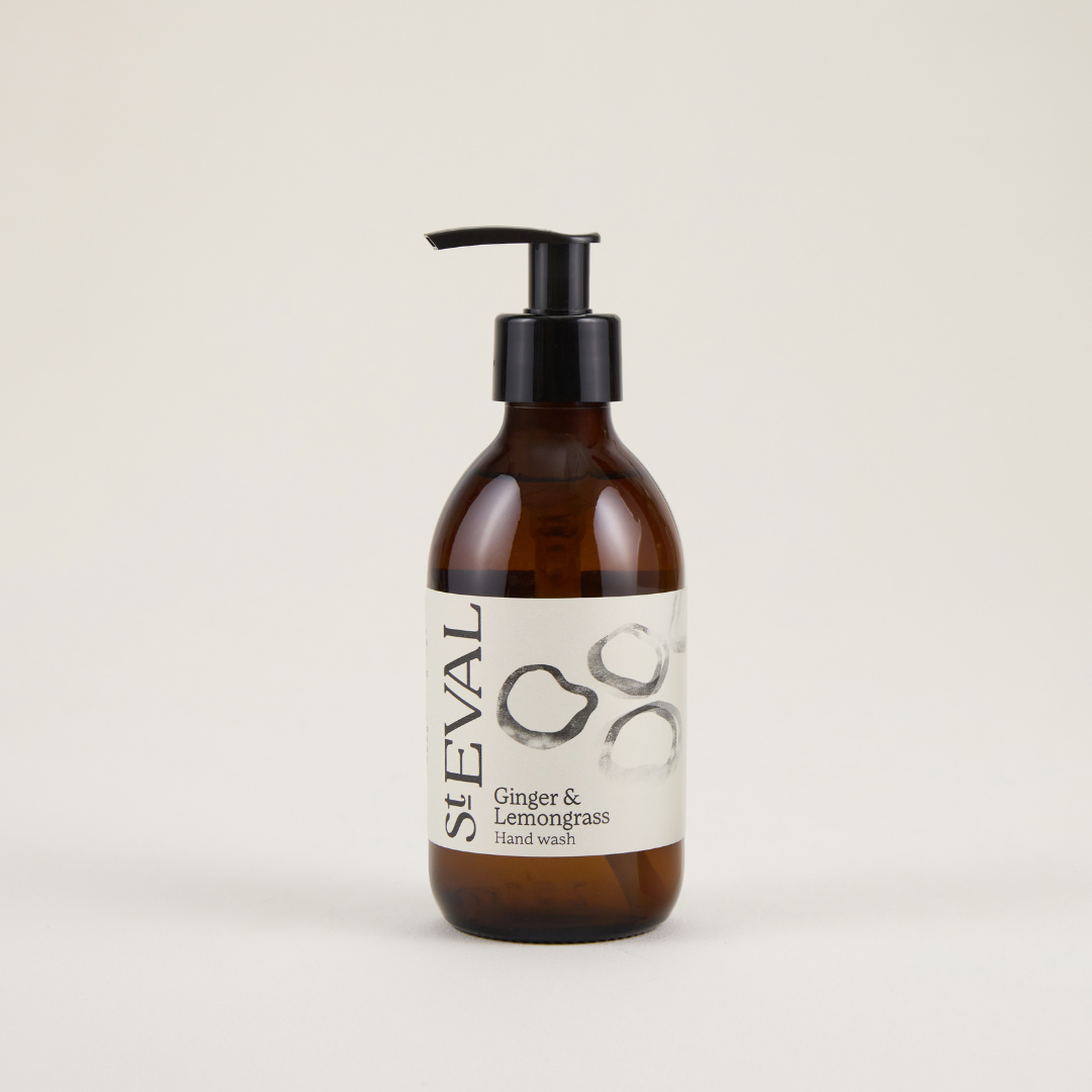 Brown bottle with pump and white label on a beige background