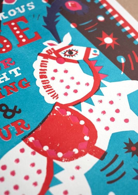 A vibrant poster featuring a stylised white horse rearing on its hind legs, adorned with red and pink decorations. The text reads, "THE WORLD FAMOUS HORSE A SHOW FOR YOUR DELIGHT WITH BLAZING POMP & SPLENDOUR," set against a colourful geometric background.