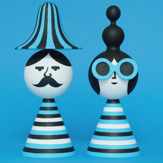 A spinning video of a pair of blue, white, and black stripey bust figures with a stripey hat and blue sunglasses on a plain blue background.