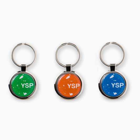 Three circular keyrings featuring vibrant backgrounds in green, orange, and blue, each displaying the letters "YSP" in white. The keyrings have a shiny metallic finish and are attached to a silver keychain.