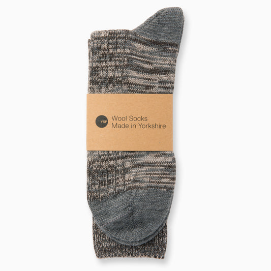 A pair of brown and grey marl wool socks with a brown cardboard belly band featuring the YSP logo.