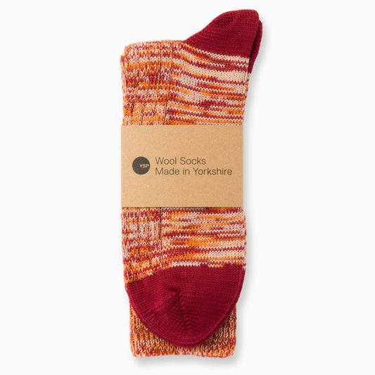 A pair of claret and orange marl wool socks with a brown cardboard belly band featuring the YSP logo.