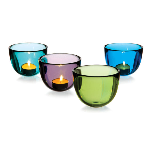 Four decorative glass candle holders in varying colours—blue, purple, green, and turquoise—each containing a lit tealight candle. The holders have a smooth, rounded design, creating a warm and inviting atmosphere.