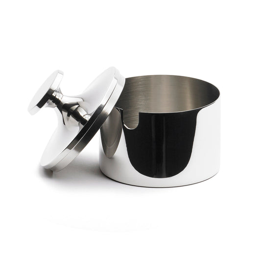 A sleek, silver stainless steel container with a smooth, rounded design. The lid is slightly ajar, revealing a polished interior. The container features a small notch on the side, adding a modern touch to its elegant appearance.