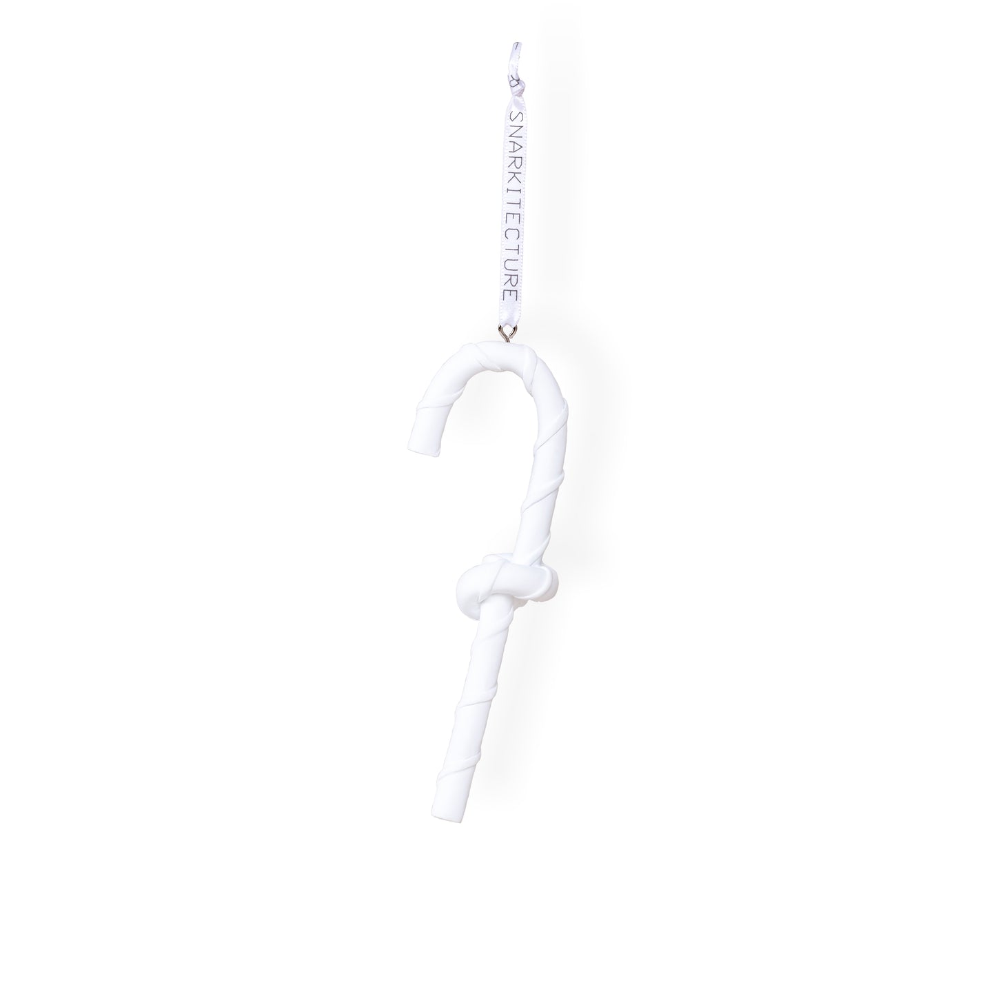 A white, twisted candy cane ornament hangs from a ribbon. The design is minimalist, featuring a smooth, curved shape with a knot in the middle. The ribbon is labelled with the brand name "SNARKitecture.