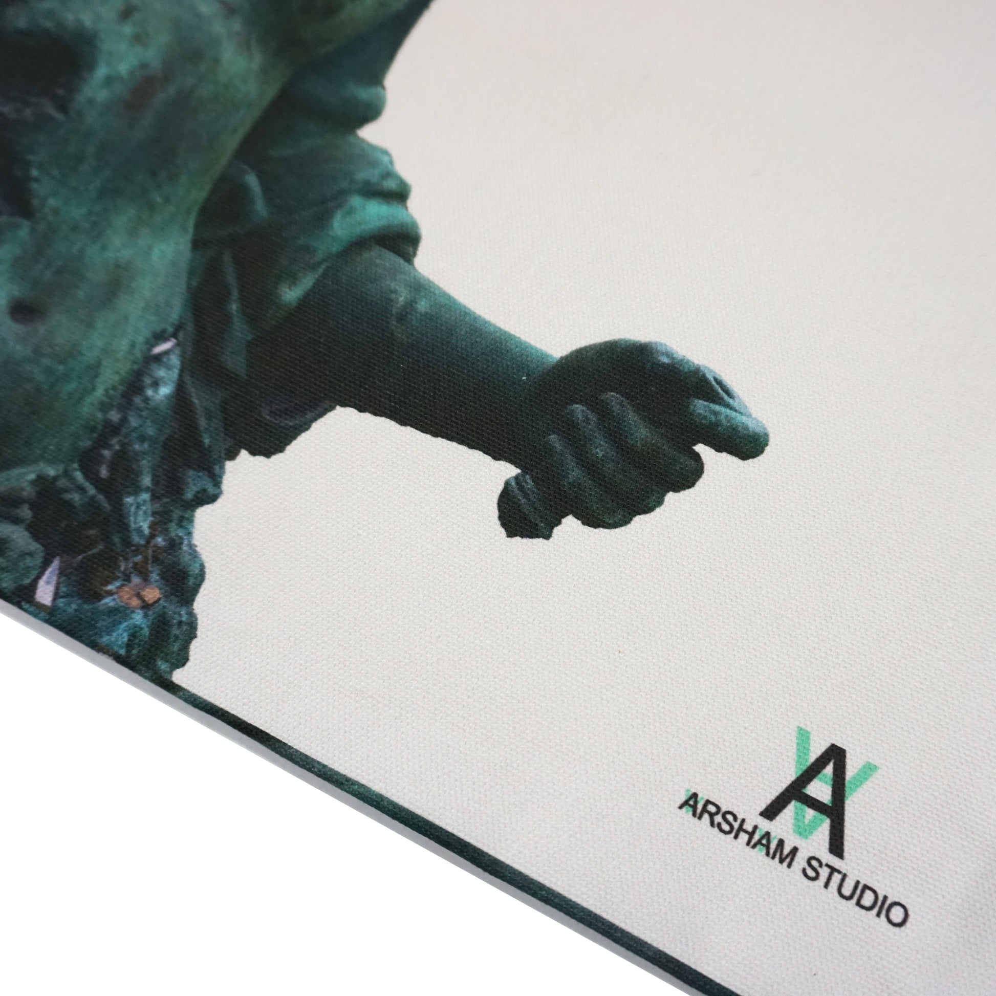 A close-up of a textured canvas featuring a green-toned sculpture's hand, gripping an object. The bottom corner displays the logo of Arsham Studio in black and green. The background is neutral, highlighting the artwork's details.