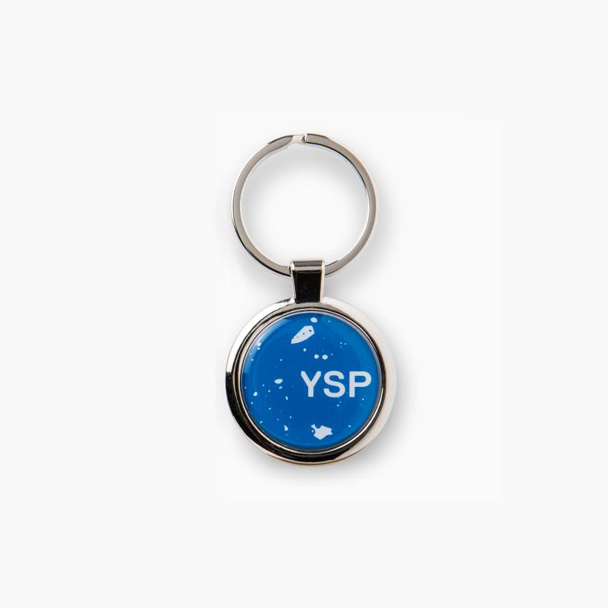 A round keyring featuring a bright blue background with the letters "YSP" prominently displayed in white. 